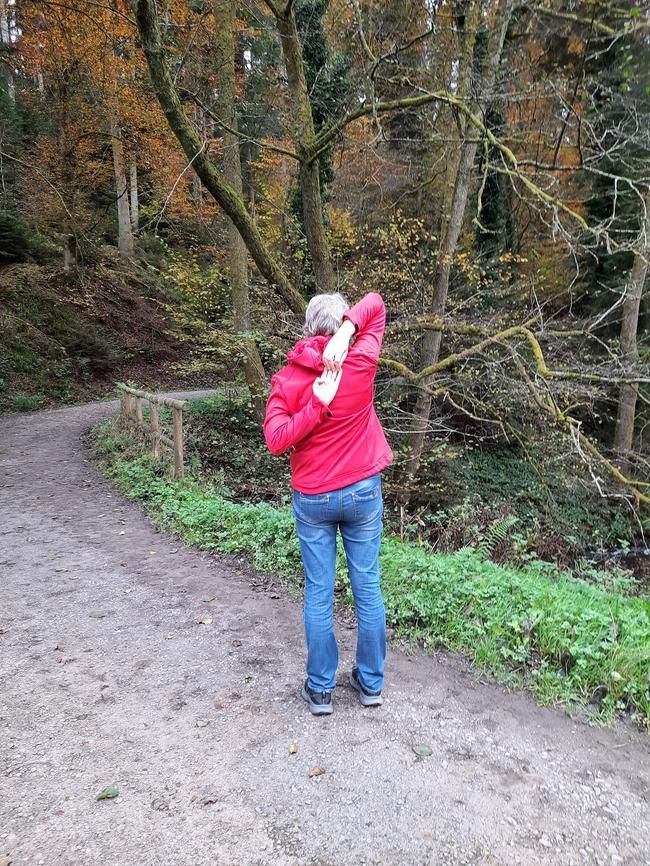 Im Wald, eine Frau, die sich dehnt