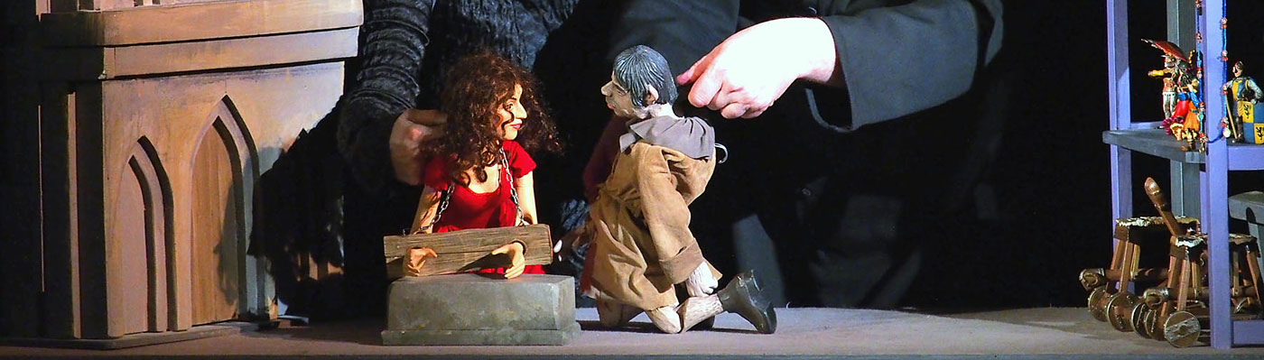 Die Puppenspieler von Theater con Cuore im Bühnenbild vor Notre Dame spielen mit den Puppen Esmeralda und Quasimodo